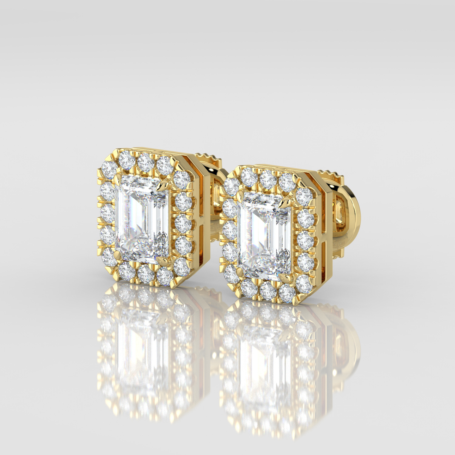 Emerald cut diamond halo earrings, yellow gold, three-quarter view