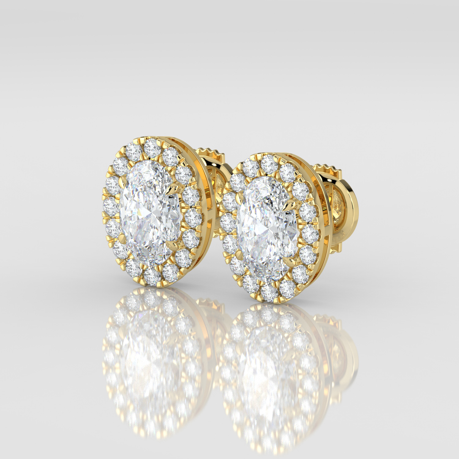 Oval cut diamond halo earrings, yellow gold, three-quarter view