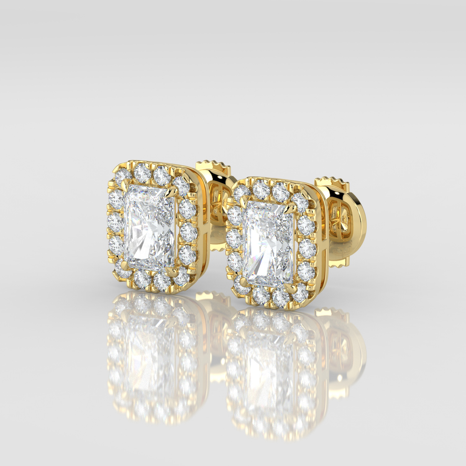 Radiant cut diamond halo earrings, yellow gold, three-quarter view