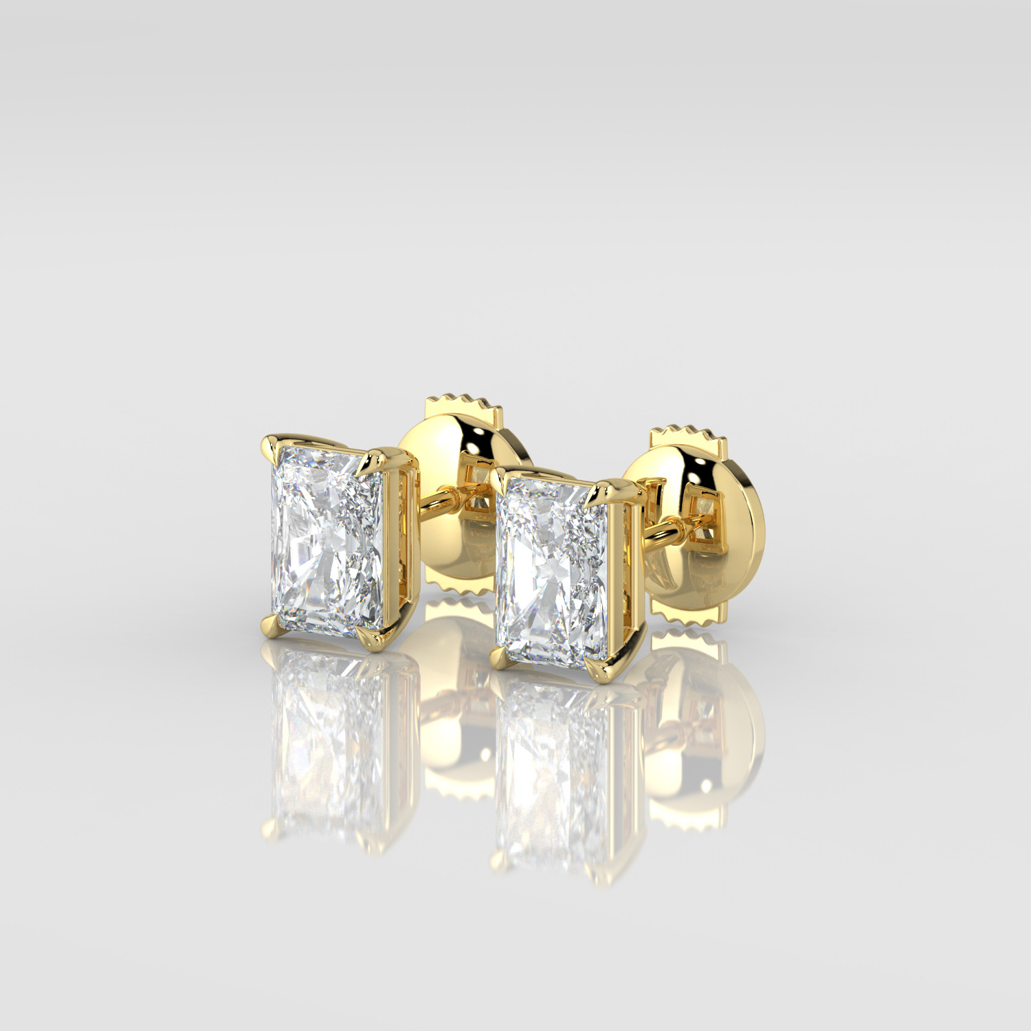 Emerald cut diamond stud earrings, yellow gold, three-quarter view