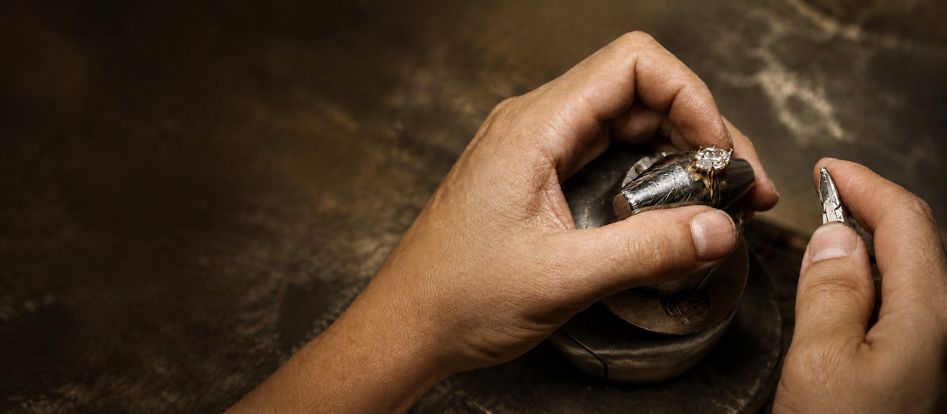 A Kinzy craftsperson hand-finishing a bespoke engagement ring in the workshop