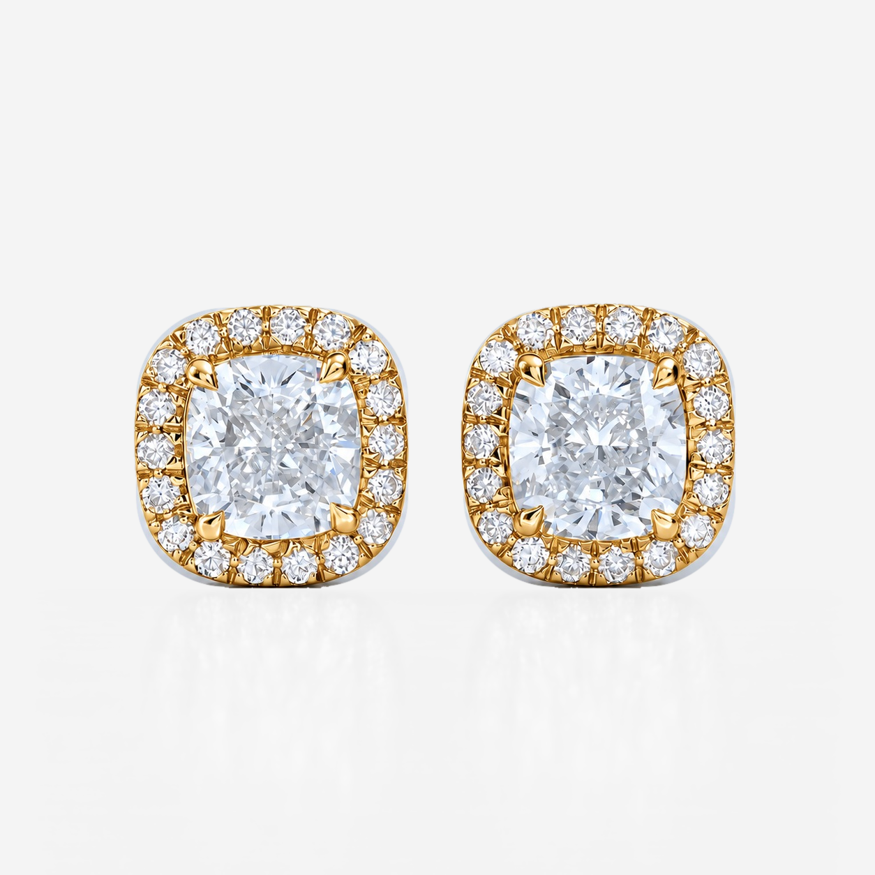 cushion halo studs in yellow gold