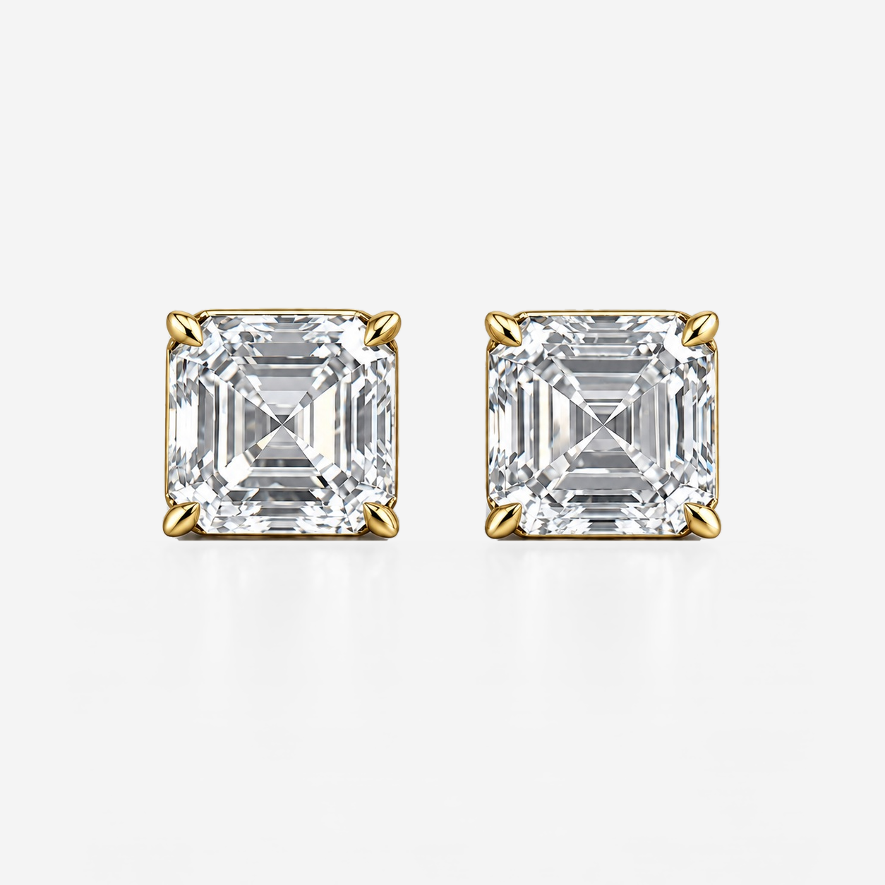 four claw asscher studs in yellow gold