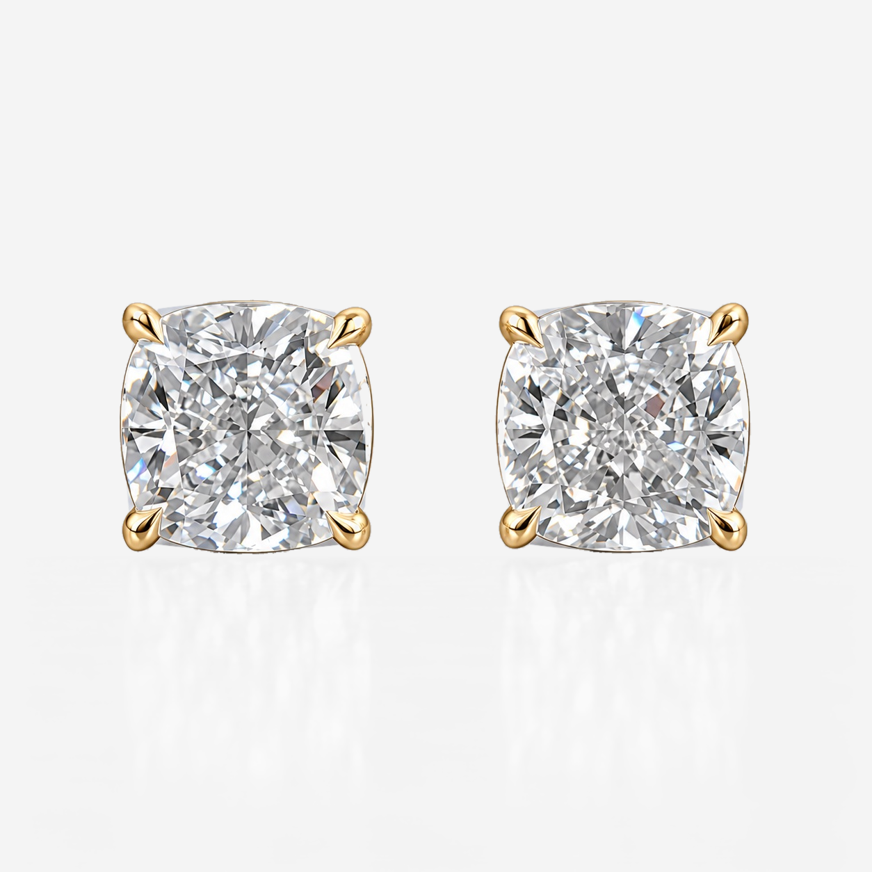 four claw cushion studs in yellow gold