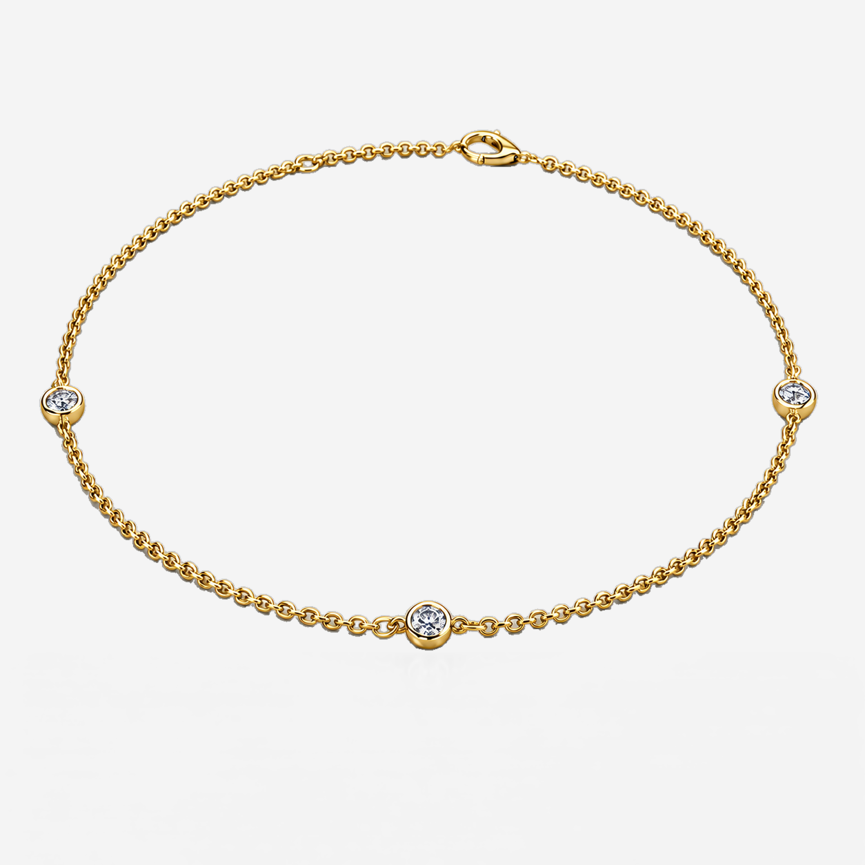Three-station bezel diamond bracelet in yellow gold