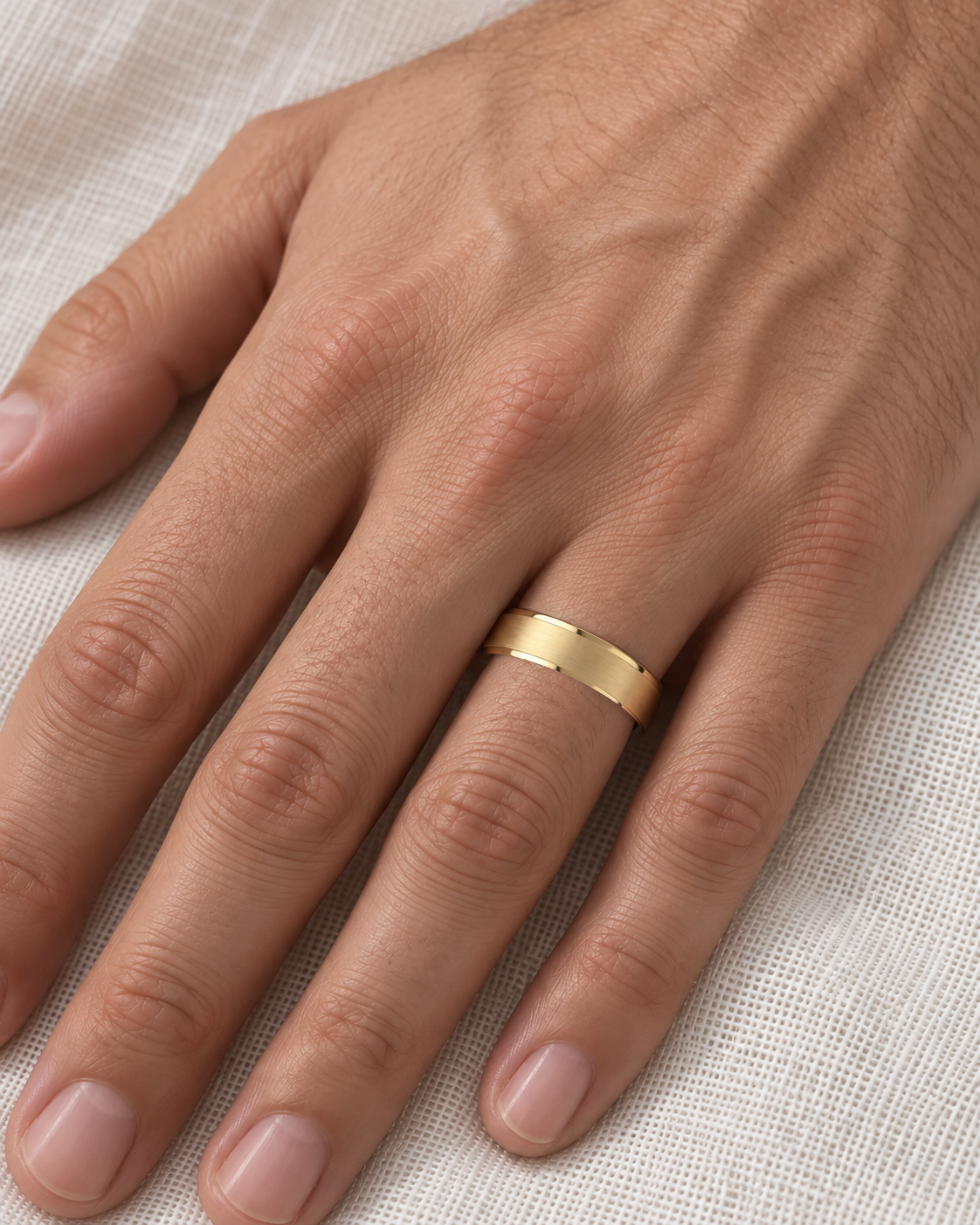 4.5mm Cut Down Edges Wedding Band in yellow gold worn on the ring finger