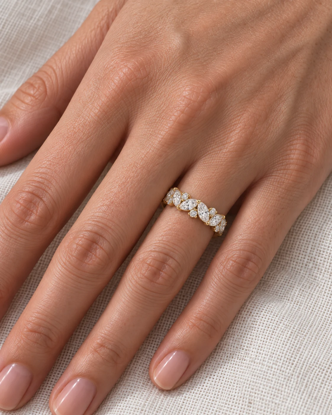 Marquise and round diamond eternity ring in yellow gold worn on the hand