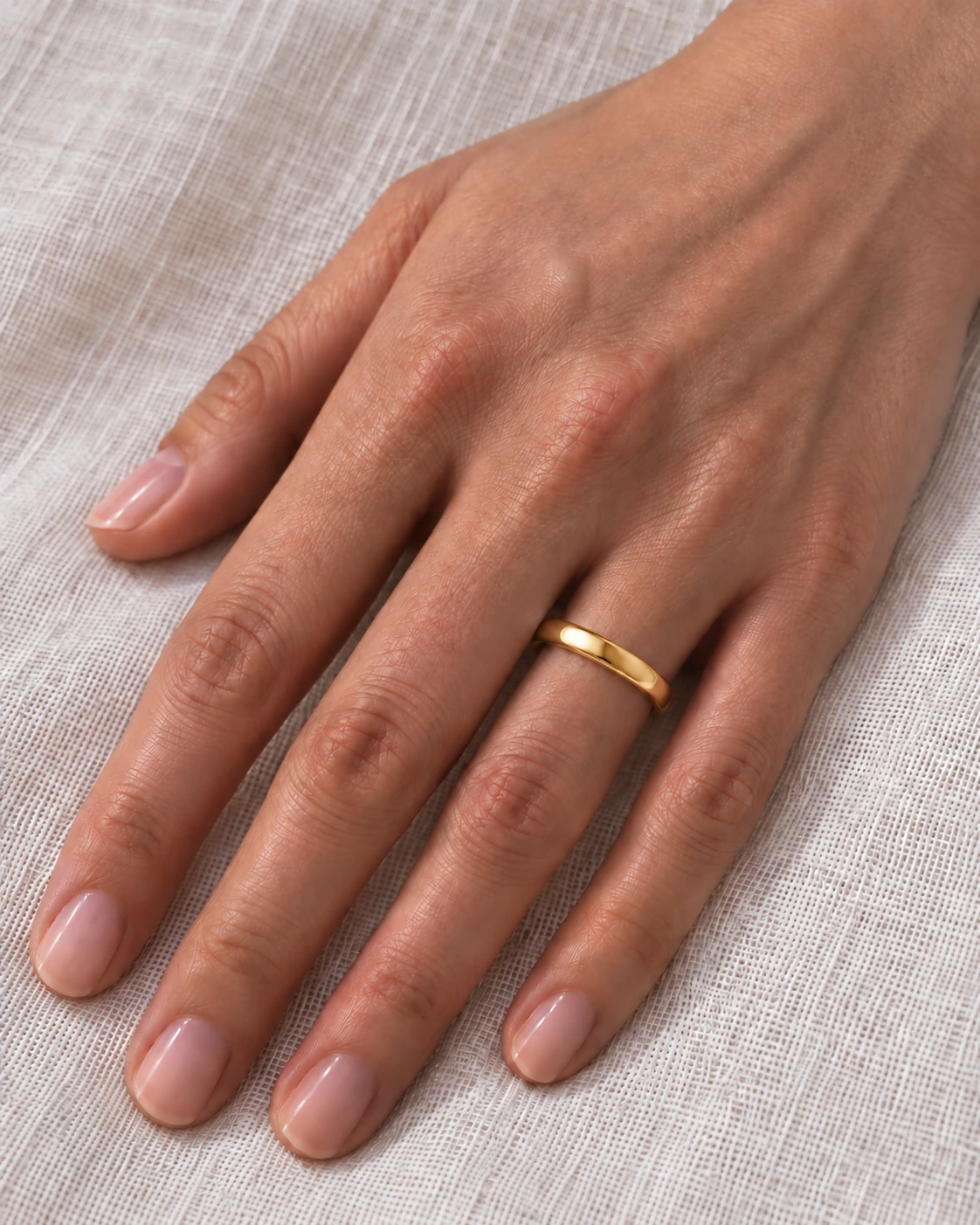 3mm Domed Court Wedding Band in yellow gold worn on the ring finger