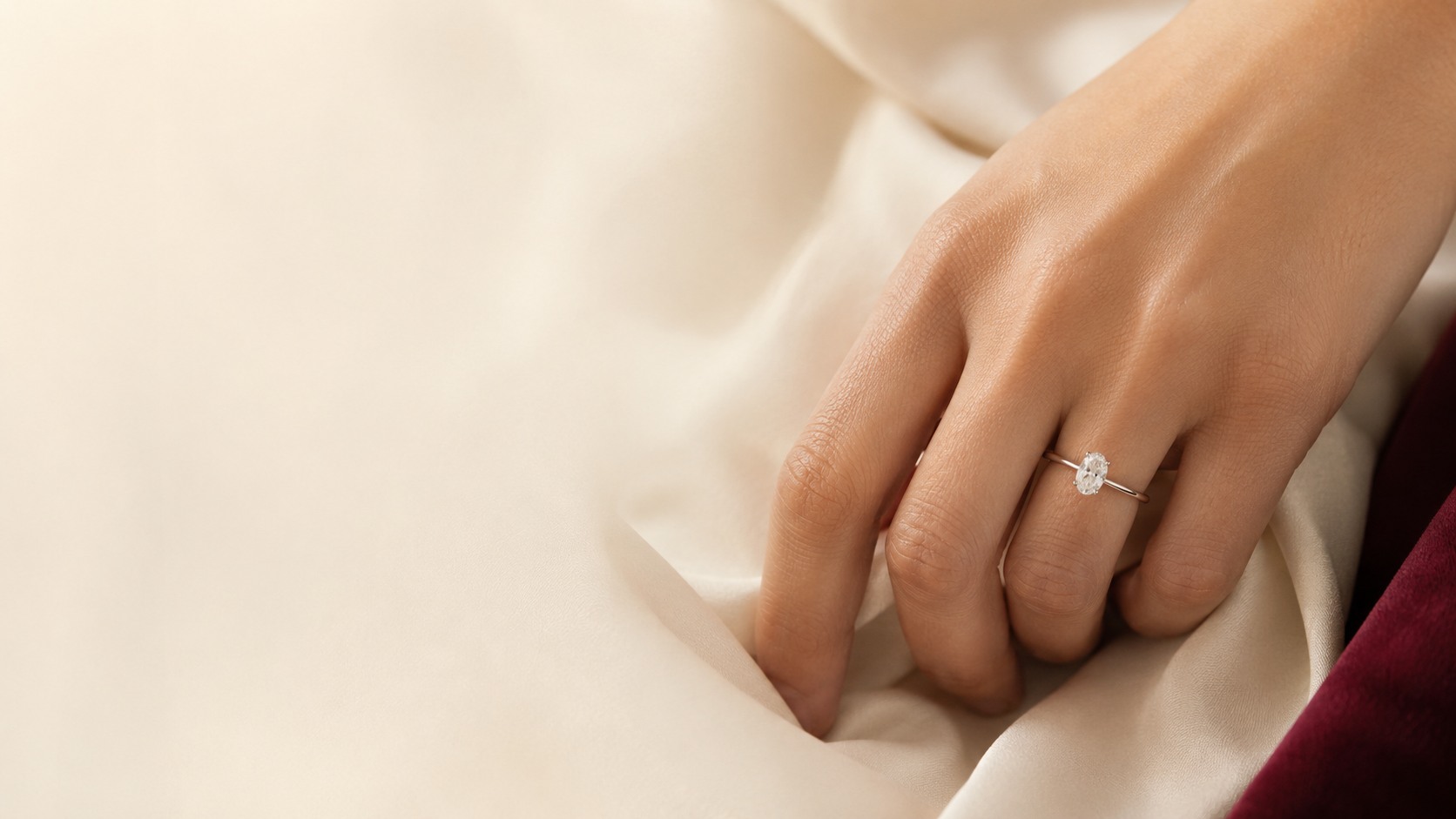 Oval diamond engagement ring worn on the hand